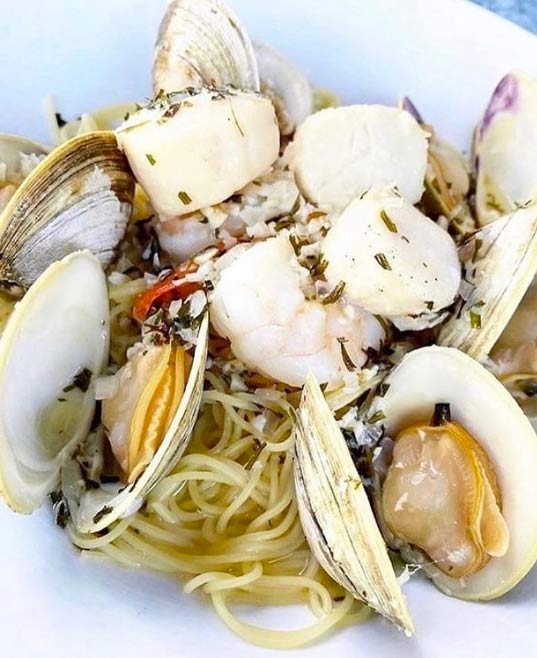 scallops and clams over pasta